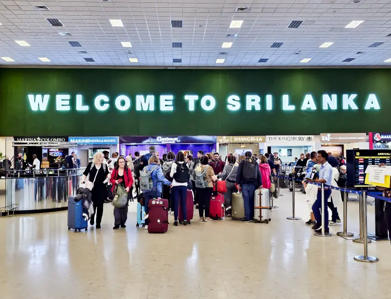 Tourist presenting passport and Sri Lanka ETA at Colombo airport immigration.